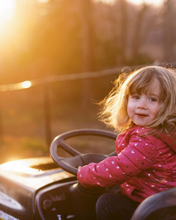 girl baby driving a mini toy car