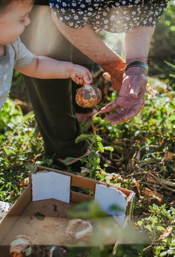 baby helping dad in the garden