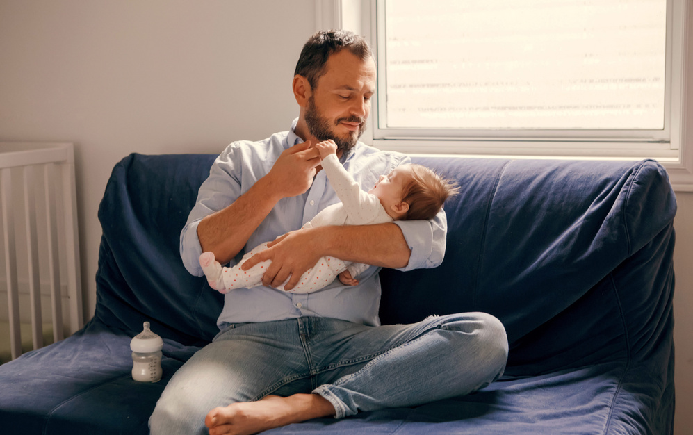 baby holding dads finger